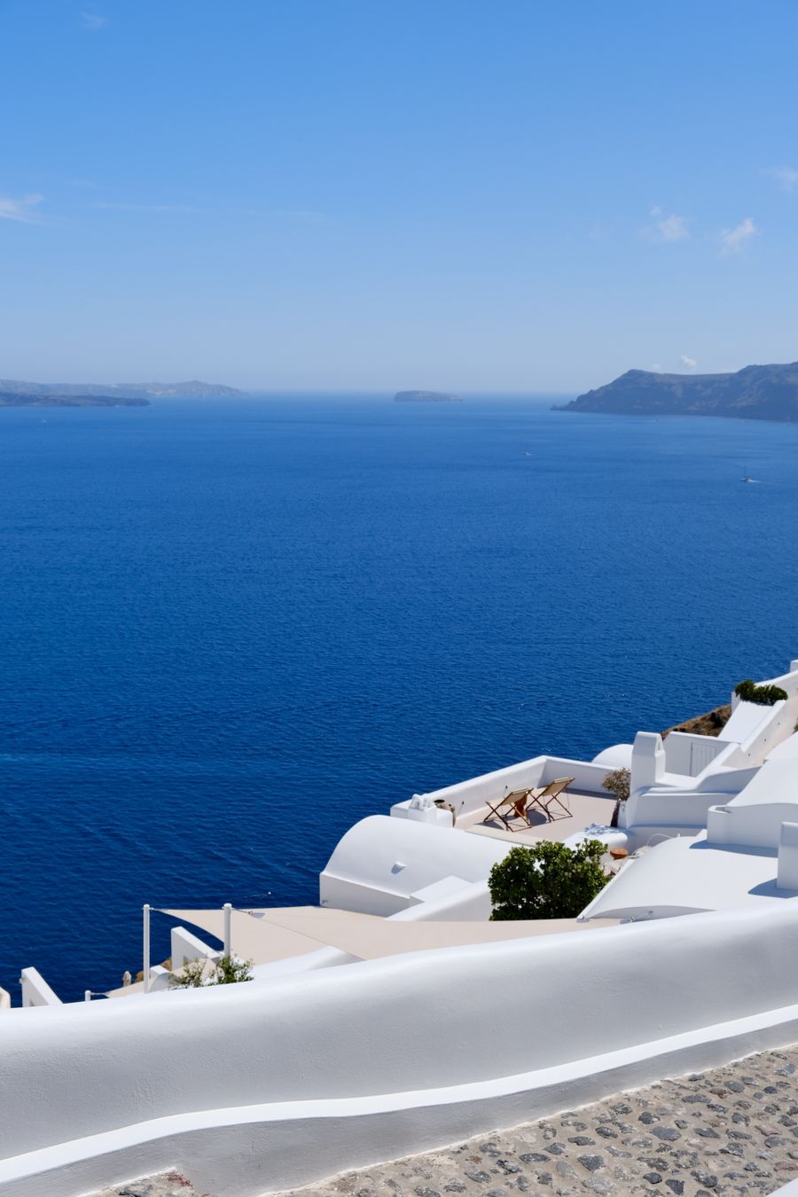 scenic view of santorini s white buildings overlooking aegean sea — Developers · Haiti: Rooftop check-in: boarding passes and hotel keys, all on the phone.