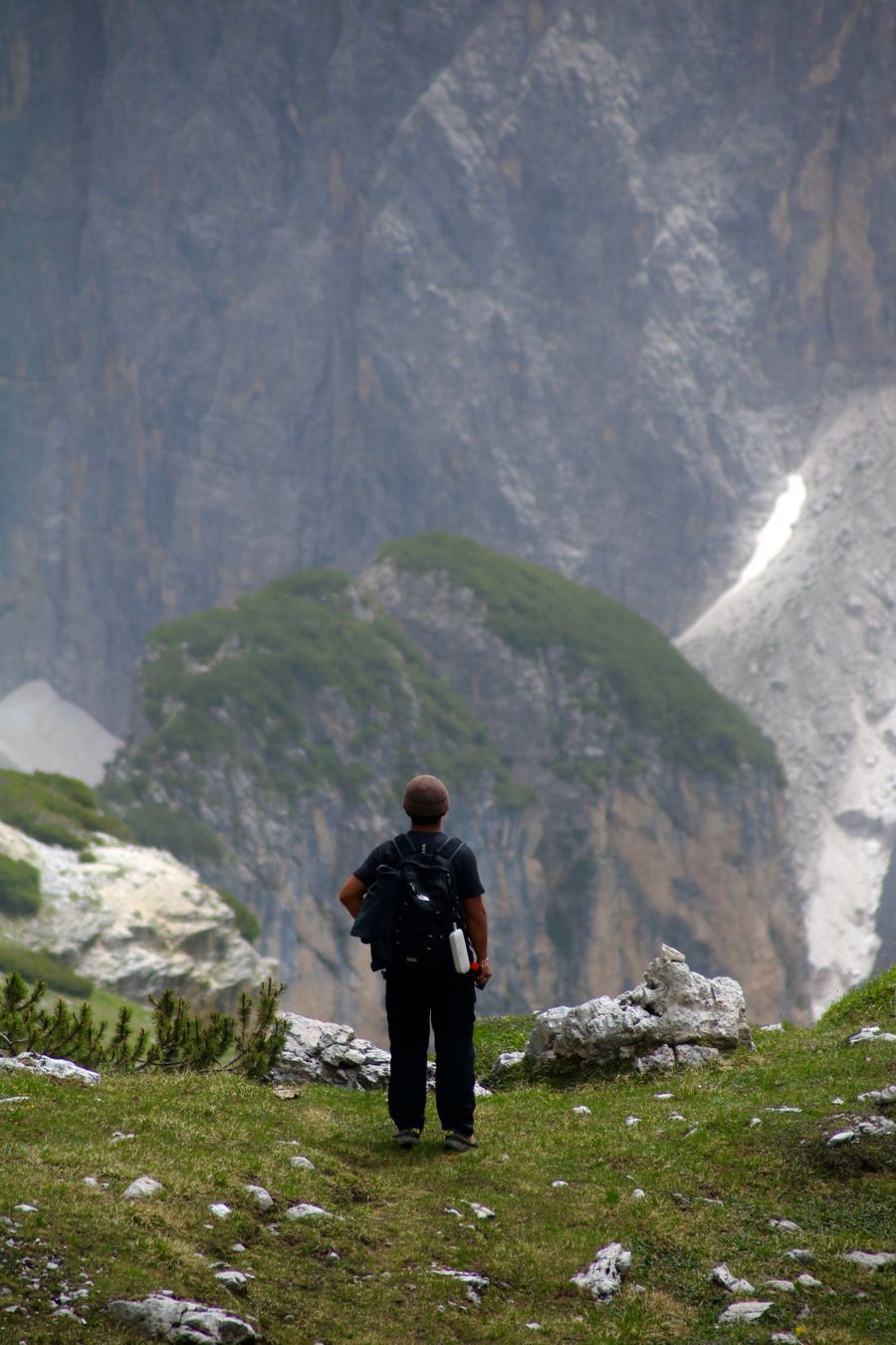 lone hiker exploring dolomite mountains landscape — Developers · Burkina Faso: The rental desk handshake: confirmation email open, license photo ready.