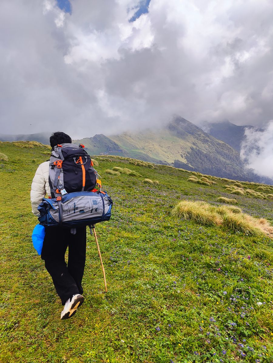 hiker trekking in lush hills of rudra nath — Developers · Belgium: Island time, online time: ferries, beaches and full signal.