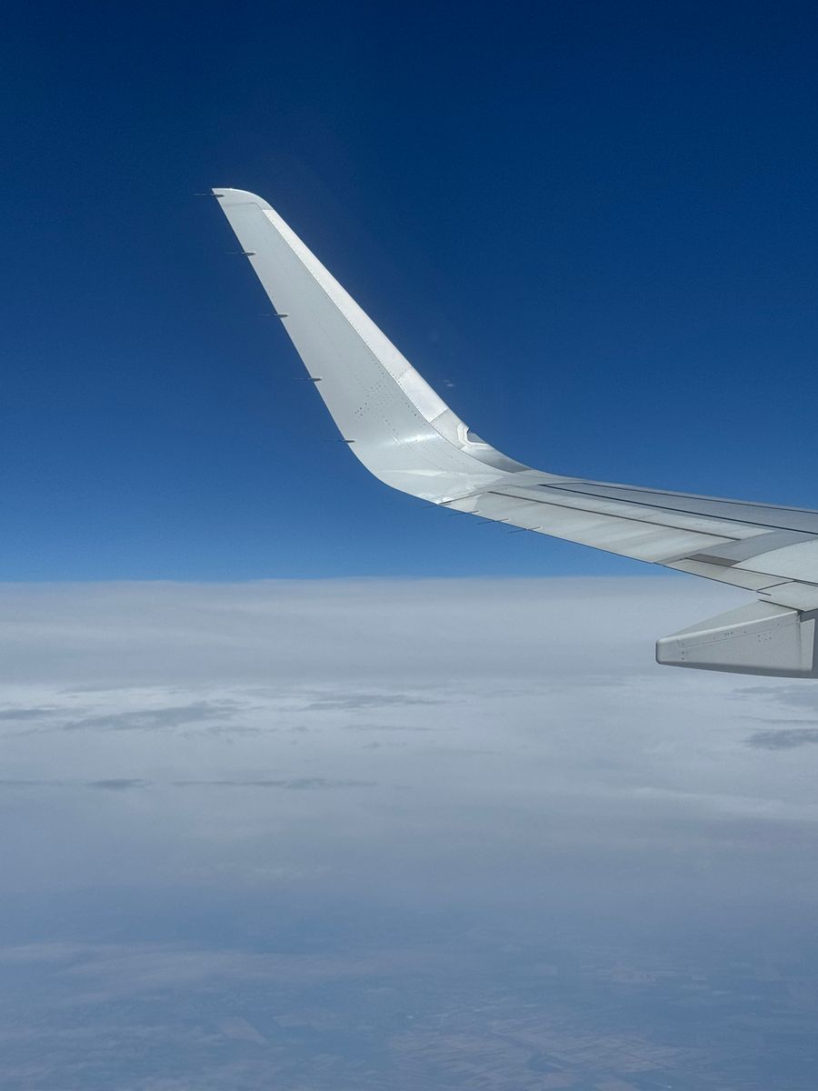 airplane wing above the clouds on a clear day