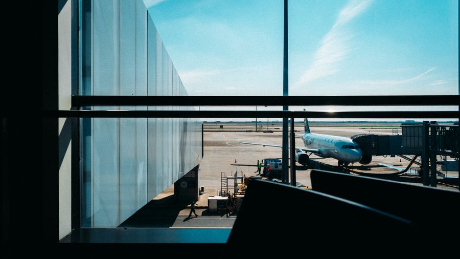 bright airport terminal with docked airplane view — Support: The support page never asks for your password — no security theater.