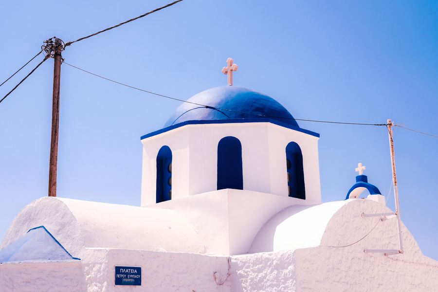 traditional blue dome church in santorini — Developers: Café office: hotspot running, video call stable, no hotel Wi-Fi roulette.