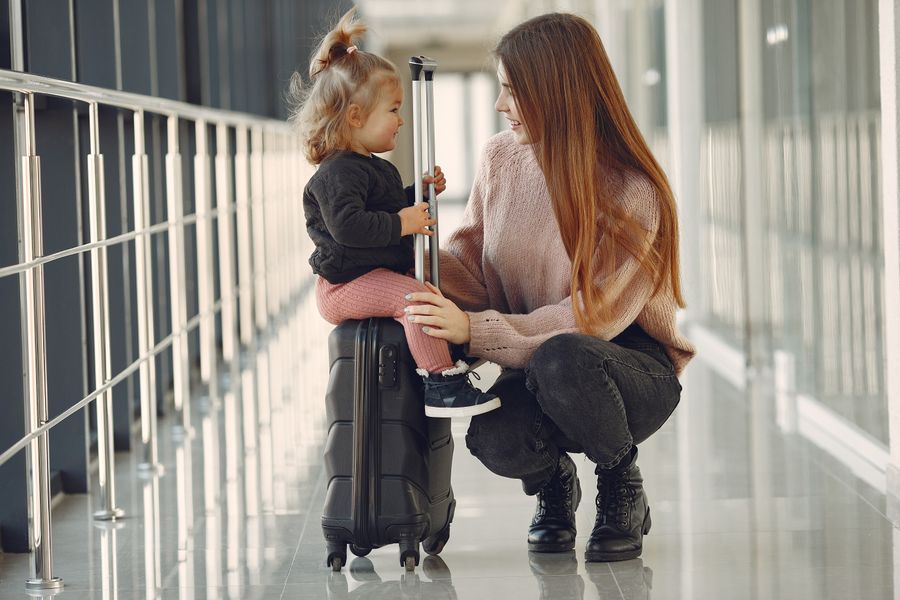 smiling mother with daughter and suitcase in airport — Developers · Lesotho: Lost in the medina, found by GPS: the blue dot never lies.