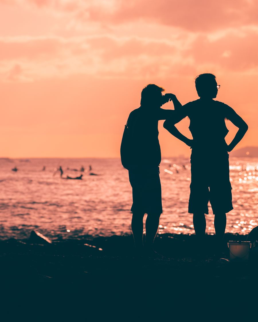 silhouette of 2 men and woman standing on beach during sunset — Developers · Cuba: Old town, new tricks: translation apps working in real time.