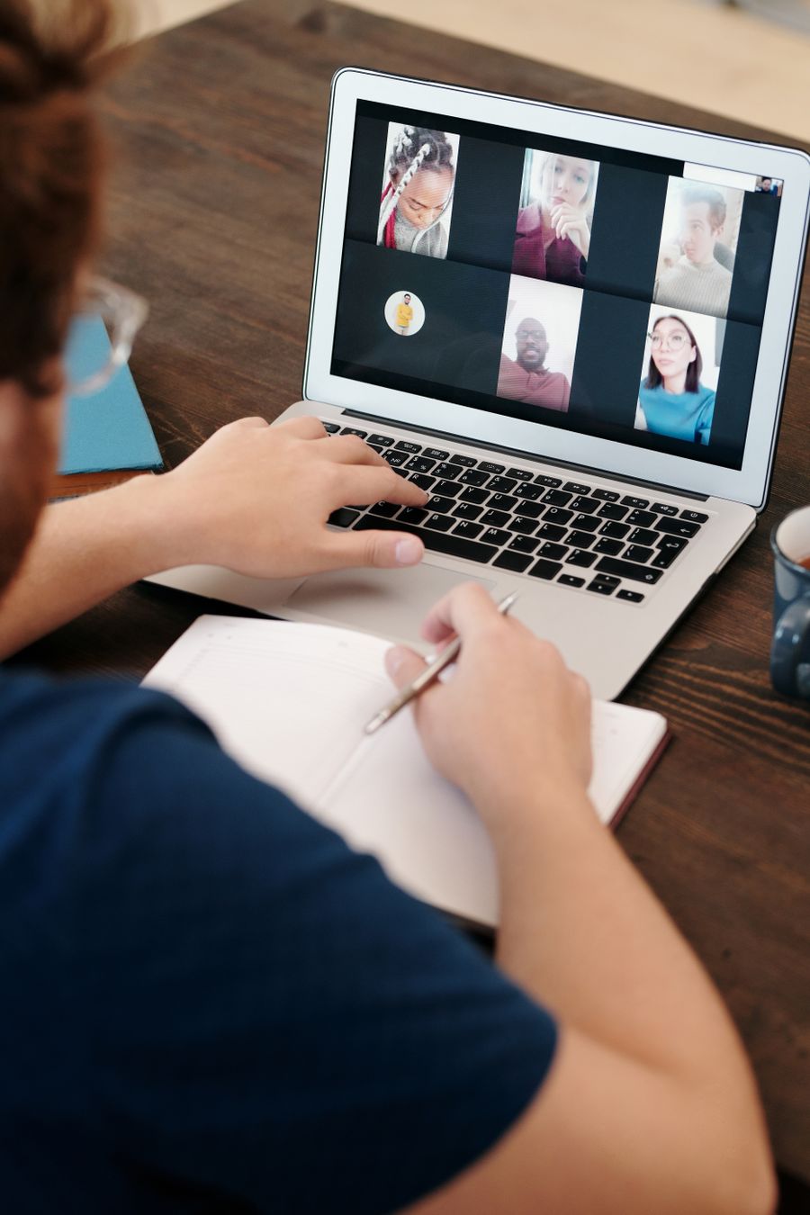 man in blue shirt having a virtual meeting — Docs: The long layover: streaming, working and messaging, all covered.