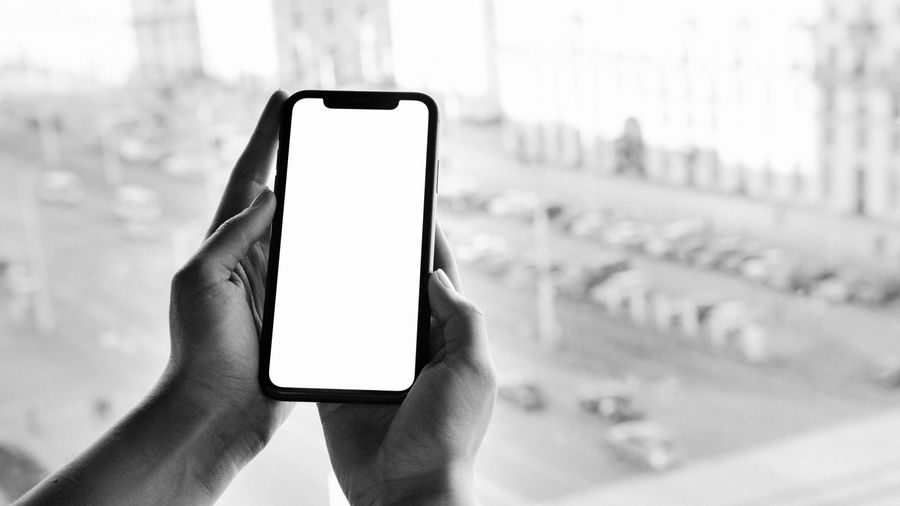 grayscale photo of person holding smartphone — Developers · Andorra: Coast roads and country lanes — the map keeps up wherever you roam.