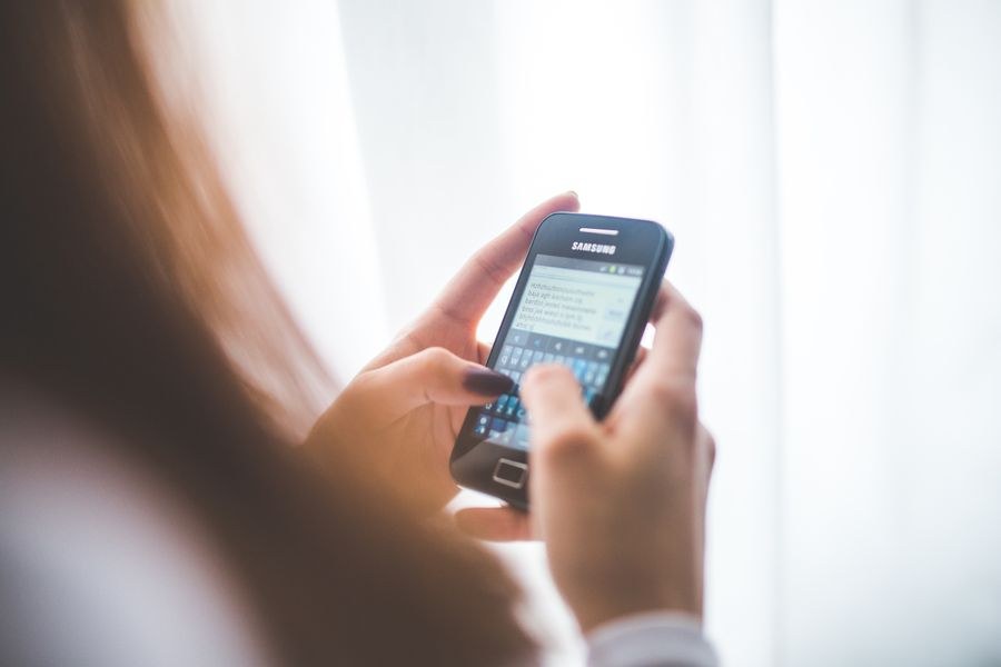 girl using mobile phone — Developers · Thailand: The welcome home: eSIM deleted in one tap, no contract to cancel.
