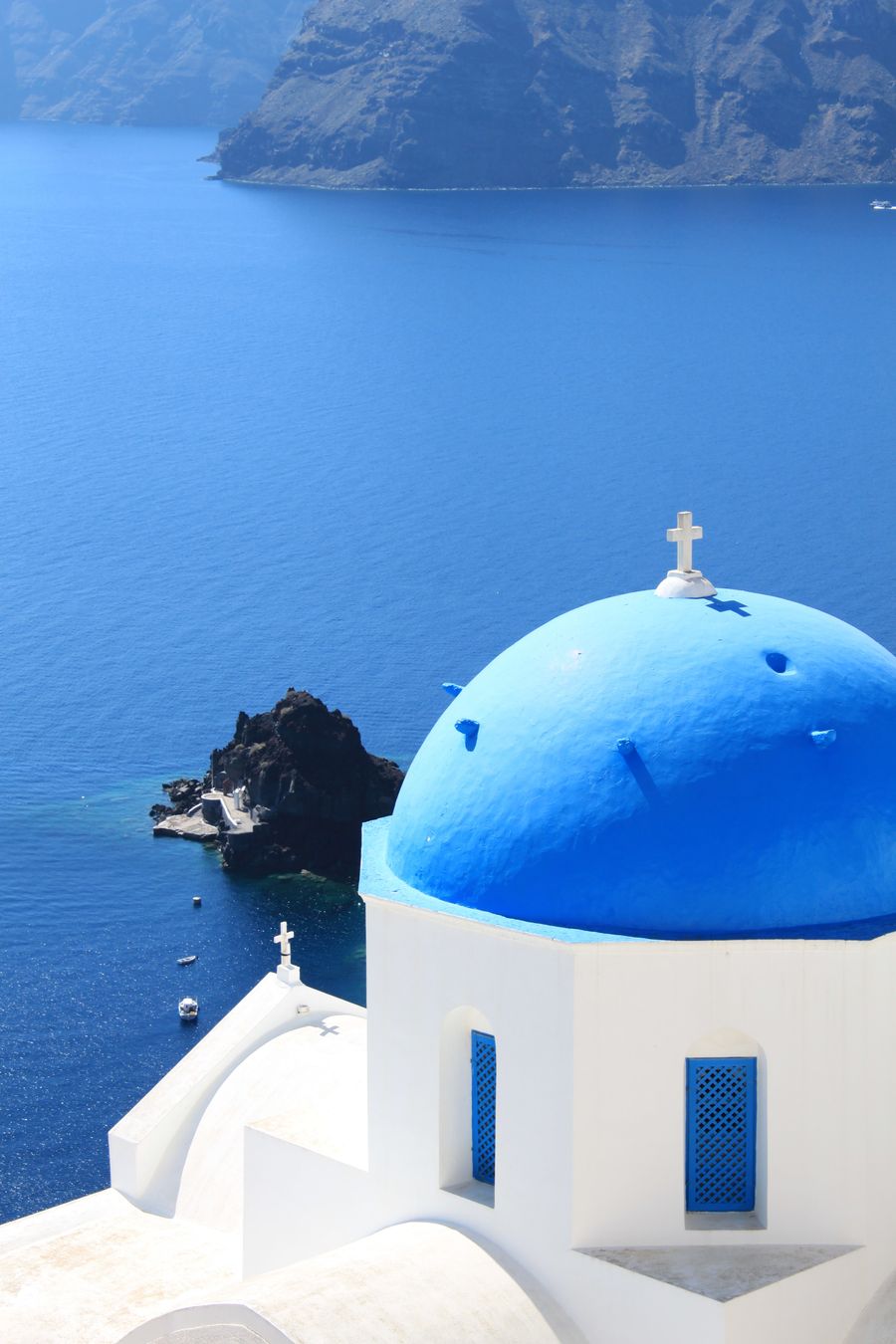 white and blue church near the ocean — Developers · Andorra: City lights after dark — the eSIM doesn't care what time it is.