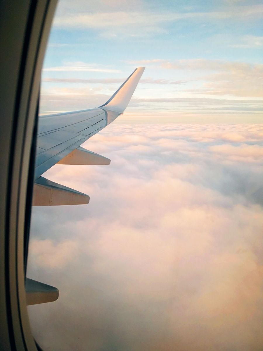 wing of aircraft flying over clouds at sundown — Developers · Moldova: The food tour: every recommendation looked up on the spot.