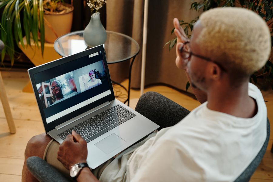 man video calling using a laptop while sitting on a chair — Developers · Estonia: The welcome home: eSIM deleted in one tap, no contract to cancel.