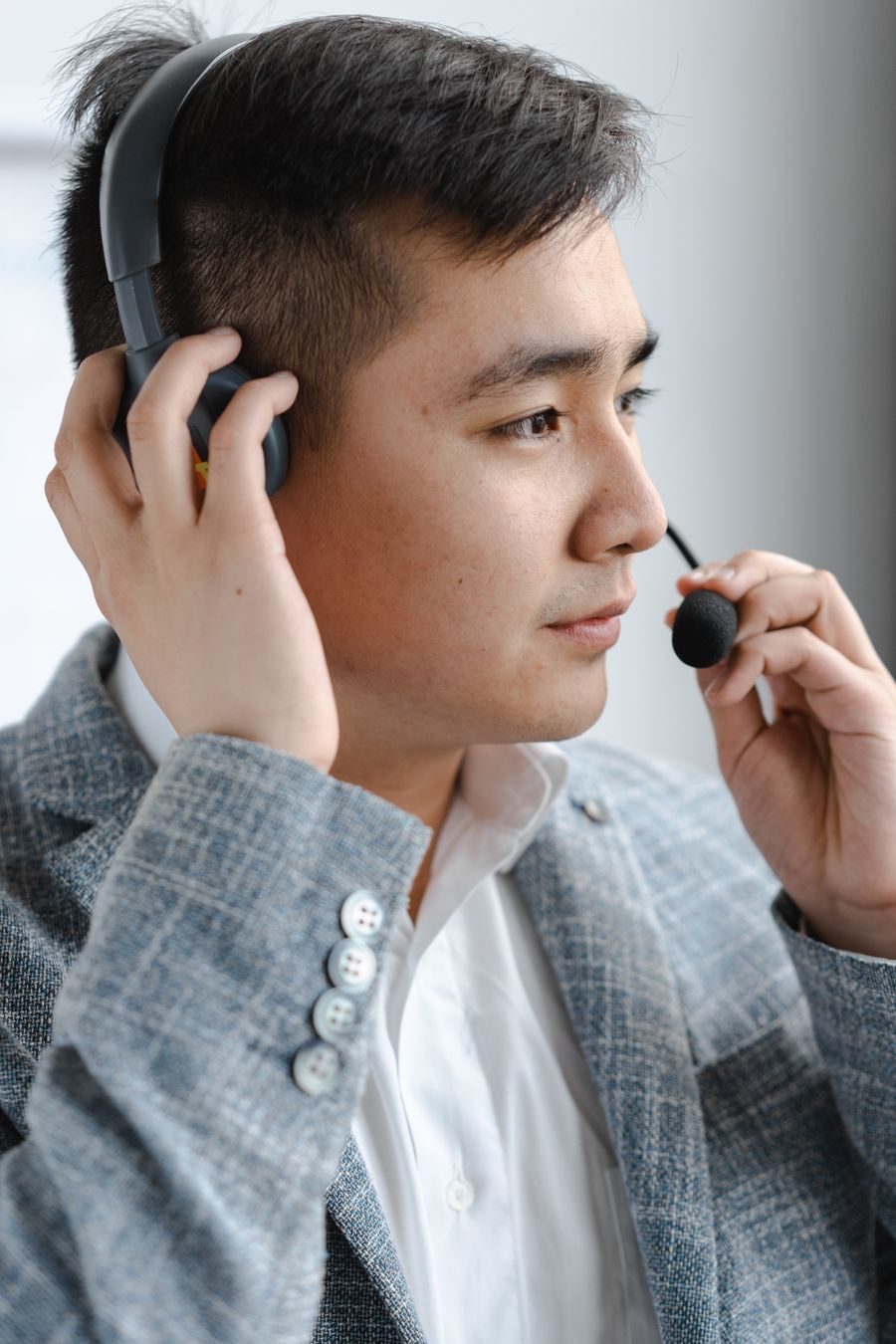 man in gray plaid jacket holding headset — Developers · Palestine: The night bus: entertainment downloaded, messages queued, rest easy.