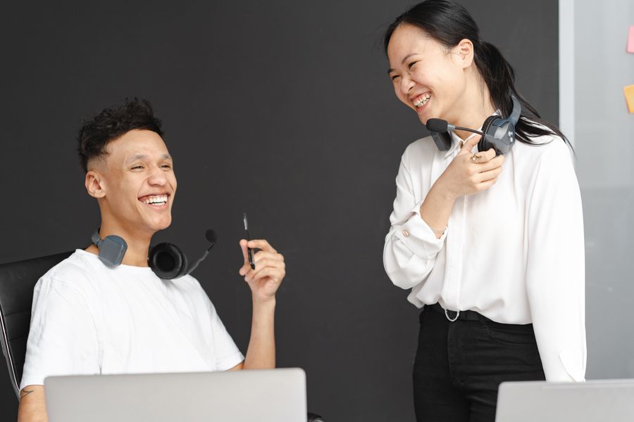 laughing man and woman working in a call center — Developers · Mauritania: The last night: photo album backed up, memories safe before wheels-up.