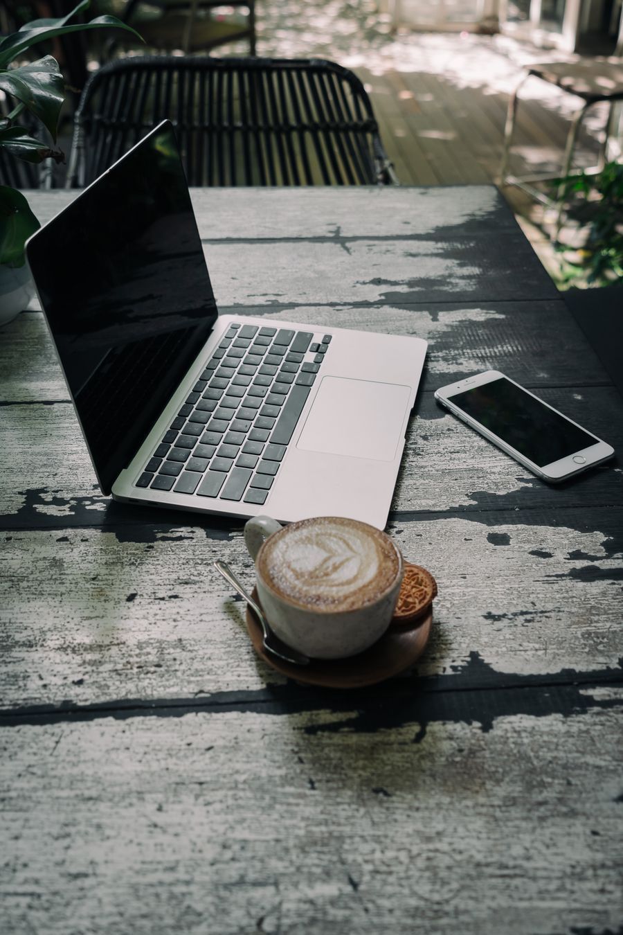 silver and black laptop near white mobile phone on wooden table