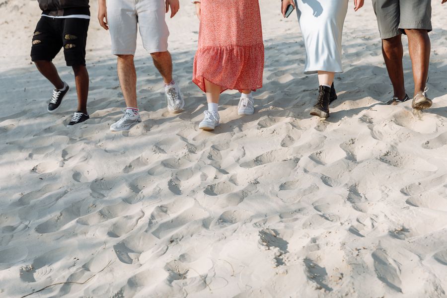 people walking on the sand — Developers: Rainy-day backup plan: indoor attractions researched from the hostel bunk.