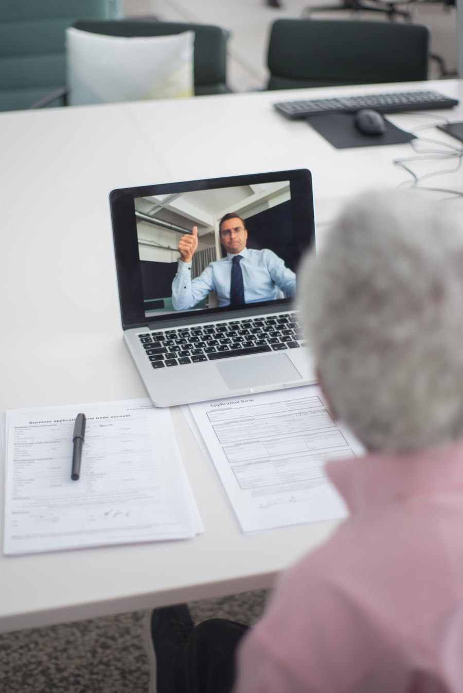 an elderly man on video call with an agent doing a hand sign — Developers · Mexico: The museum queue skips itself: tickets bought online, straight to the door.