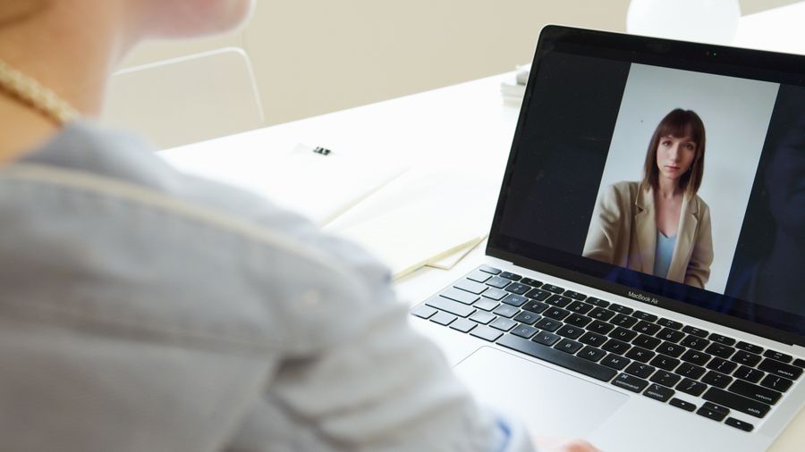 photo of a woman on the screen of a laptop — Developers · Laos: The long layover: streaming, working and messaging, all covered.
