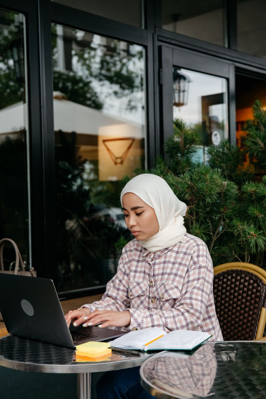 a woman in white hijab using a laptop — Developers · Finland: The commute, handled: podcasts downloaded, messages sent, no dead zones.