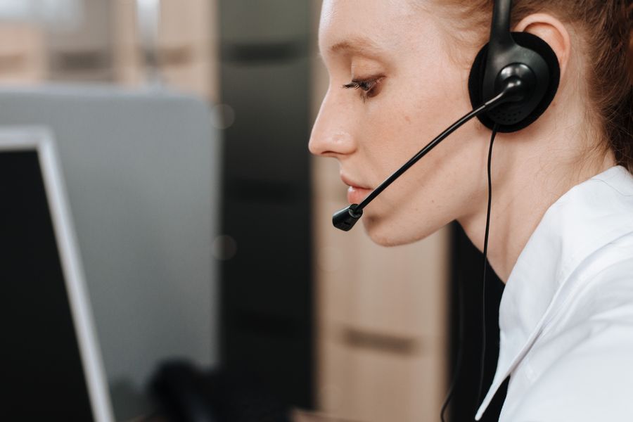 side view of a woman wearing headset — Developers · Palestine: One curl call provisions a Palestine eSIM — 200 OK in milliseconds.