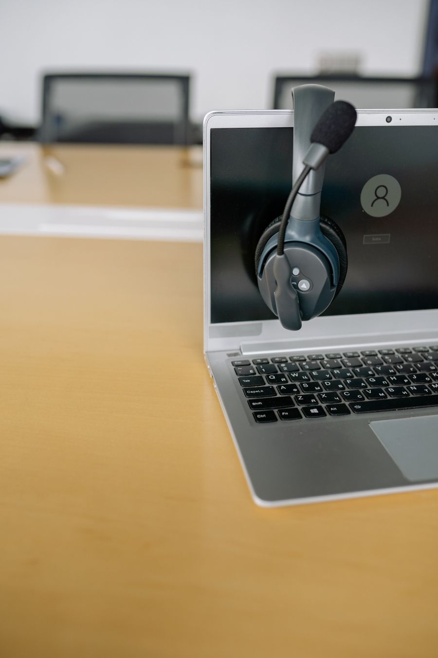 close up shot of a headset on a laptop — Docs: The night bus: entertainment downloaded, messages queued, rest easy.