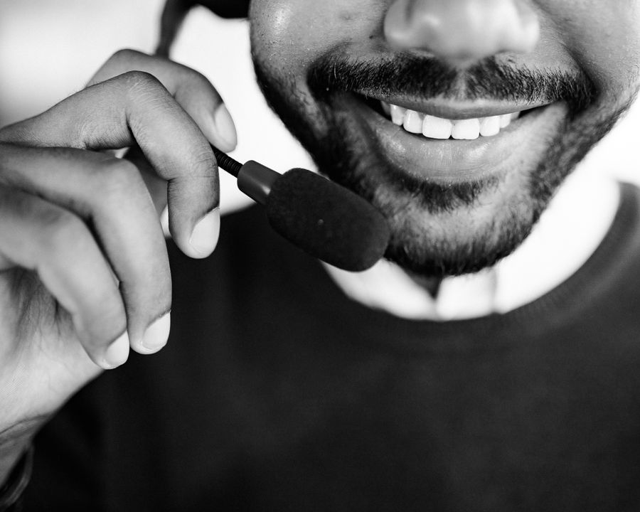 grayscale photo of person talking on headset