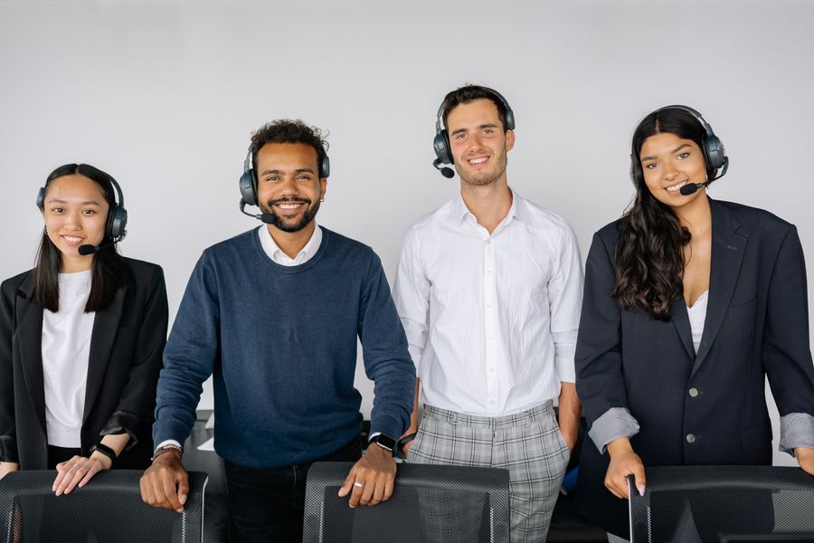 four people wearing headphones — Developers · Timor-Leste: The long layover: streaming, working and messaging, all covered.