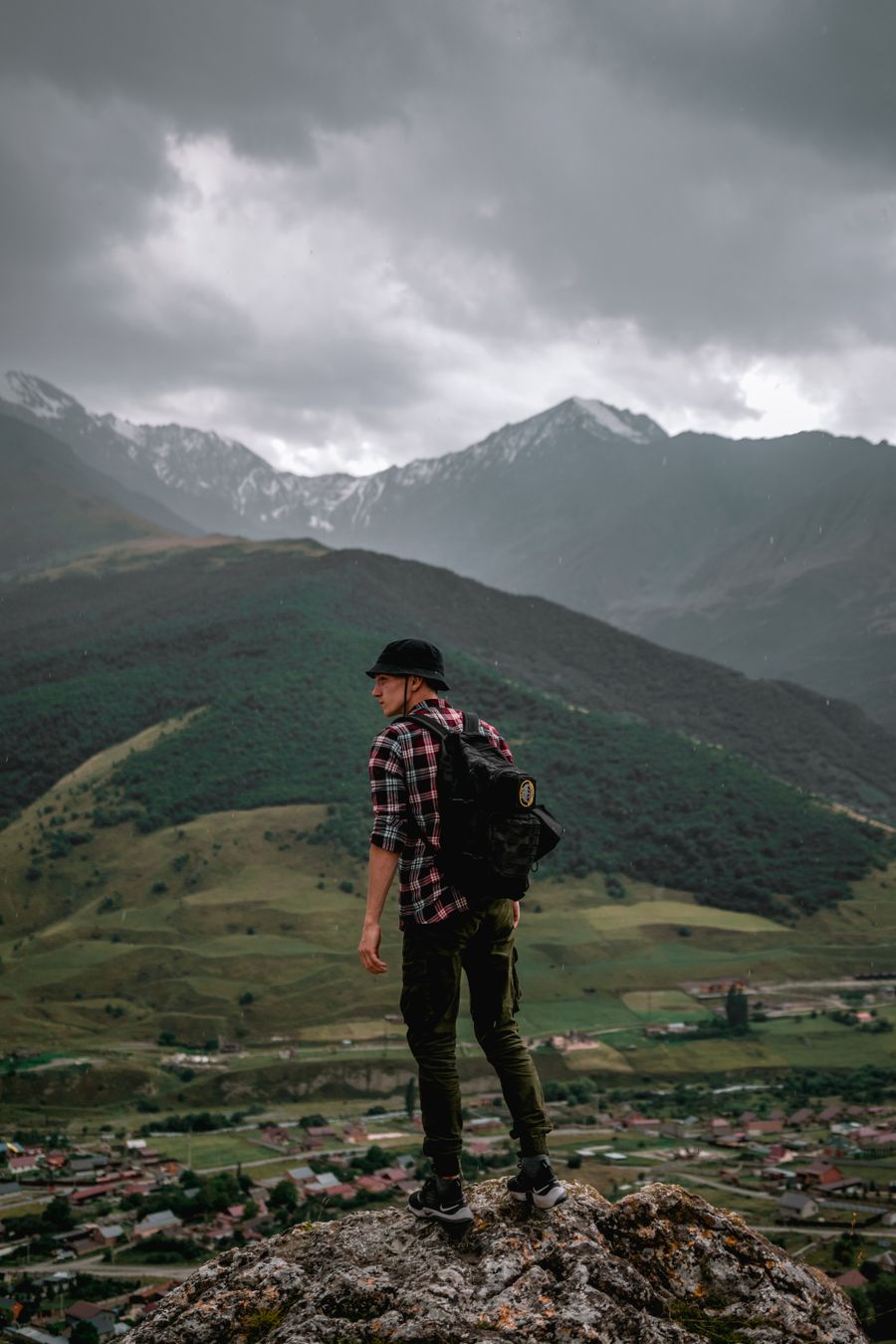 male hiker standing on the rock overlooking the green mountains — Developers · Belgium: Build on the same rails the Belgium checkout uses.