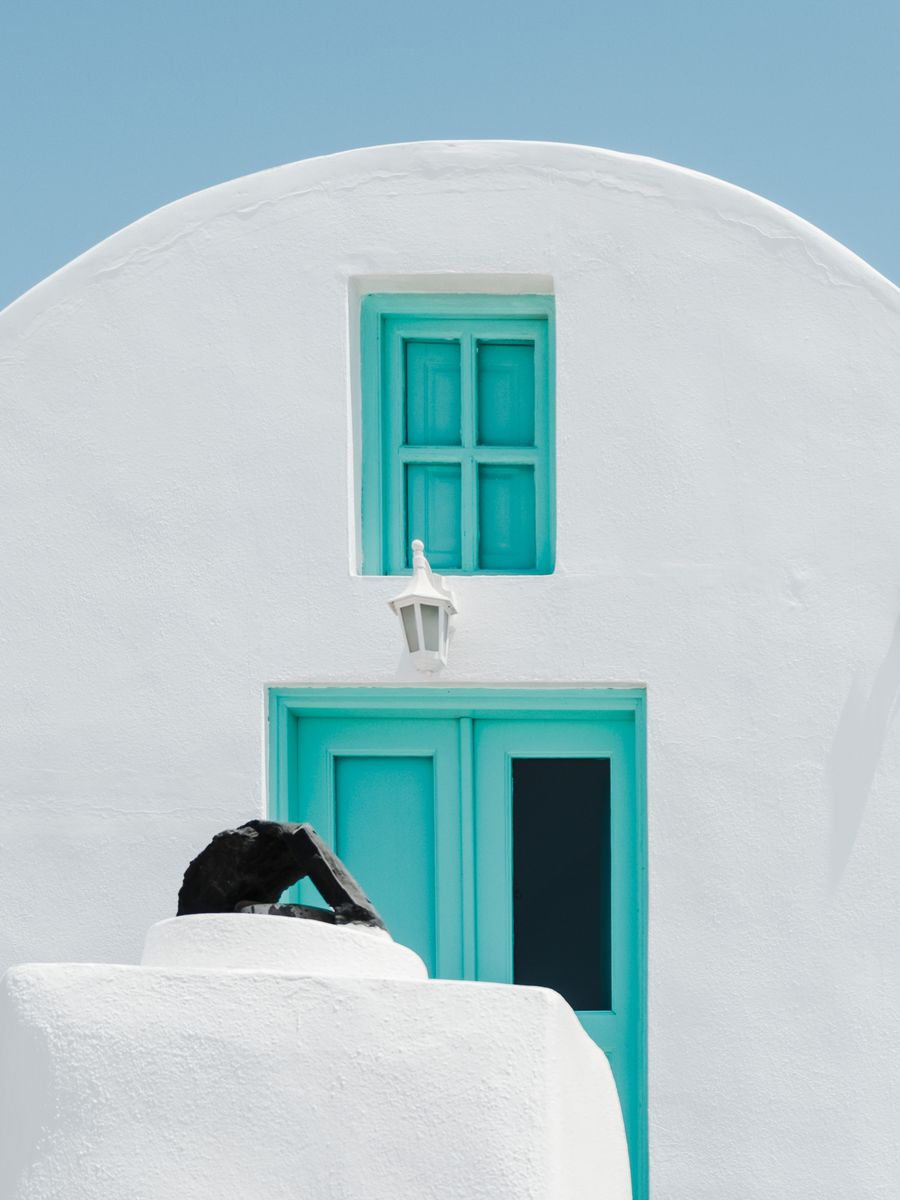 turquoise door and window on white concrete wall — Developers · Moldova: Platform to platform: tickets, timetables and taxis in one hand.