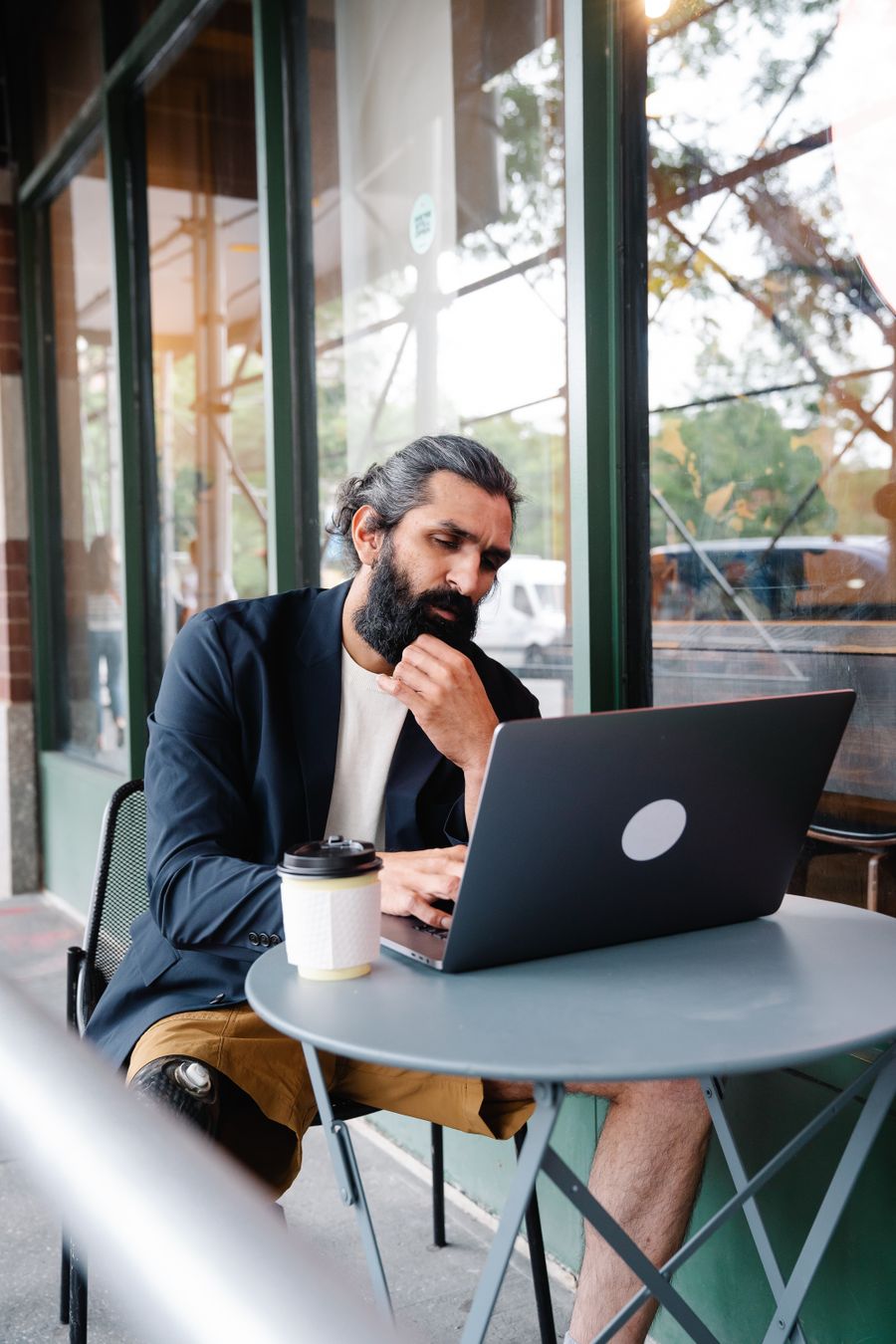 pensive man looking at laptop